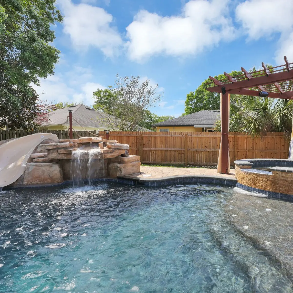 Custom pool with spa waterfall and slide