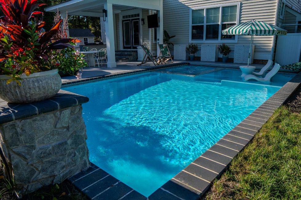 Custom gunite pool with tanning ledge and lounge chairs