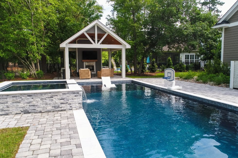 Luxury backyard pool with raised spa and covered pavilion