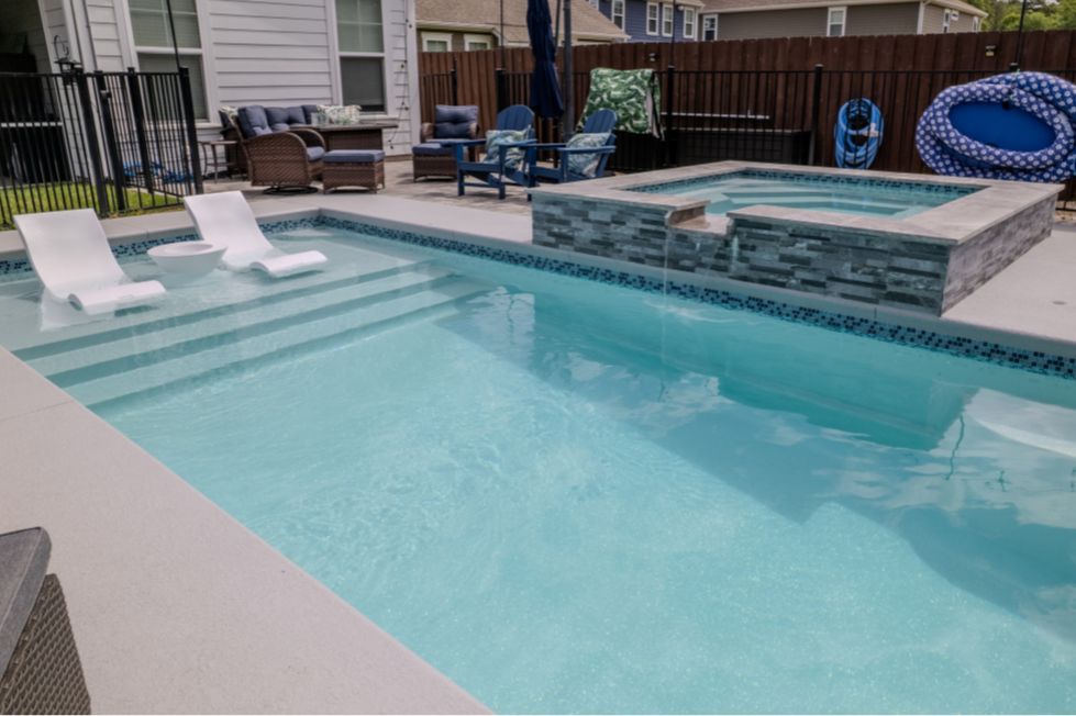 Inground pool with tanning ledge and raised spa