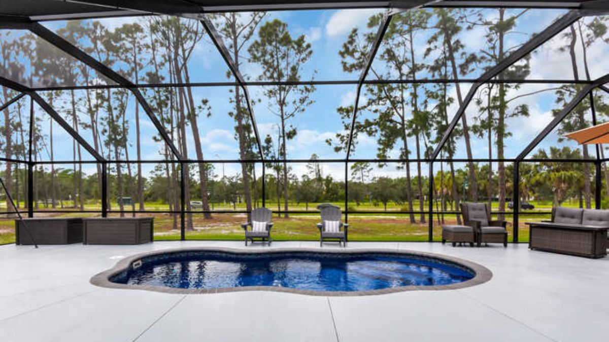 Screened lanai with a freeform fiberglass pool