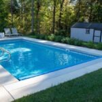 Vinyl liner pool with a concrete pool deck