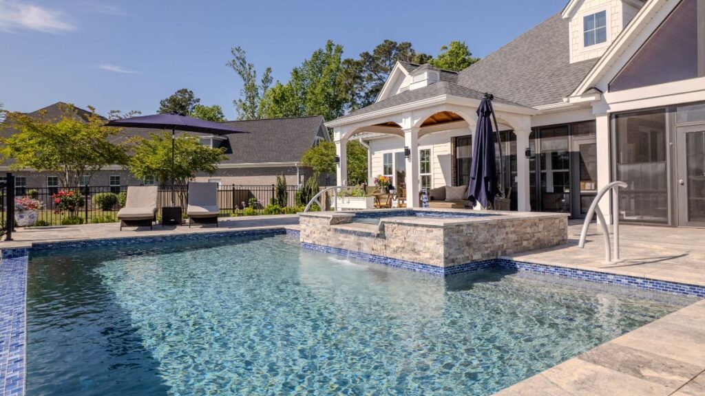 Custom gunite swimming pool with a raised spa