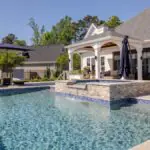 Custom gunite swimming pool with a raised spa