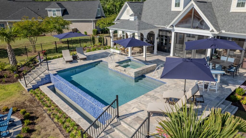 Custom gunite pool with a tanning ledge and spa