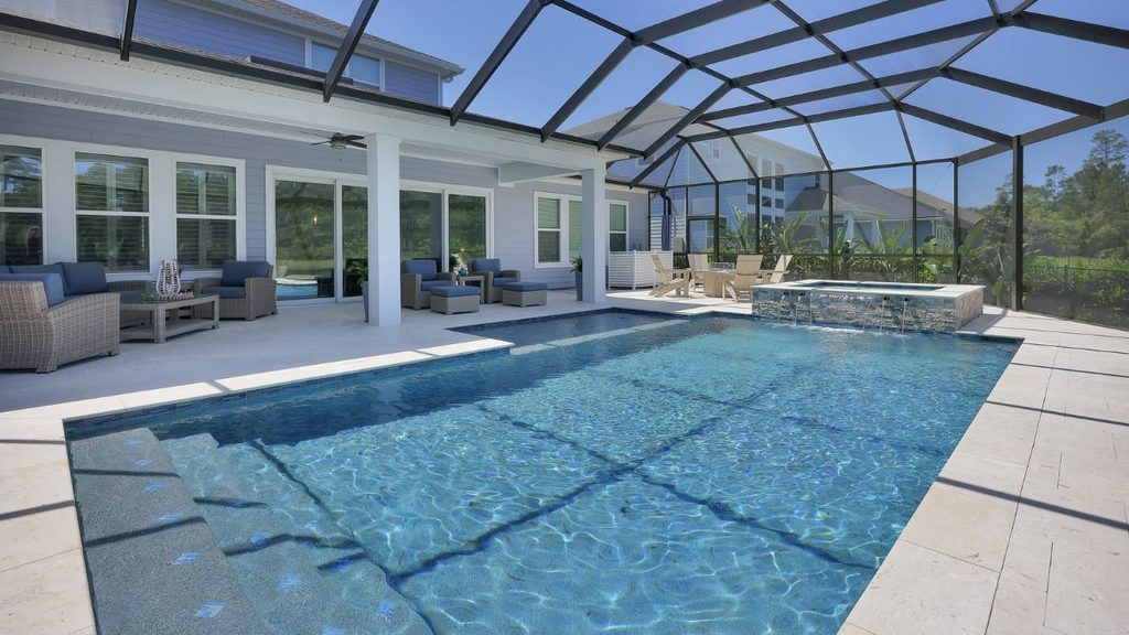 Inground pool with raised spa, screened enclosure, and covered outdoor seating area